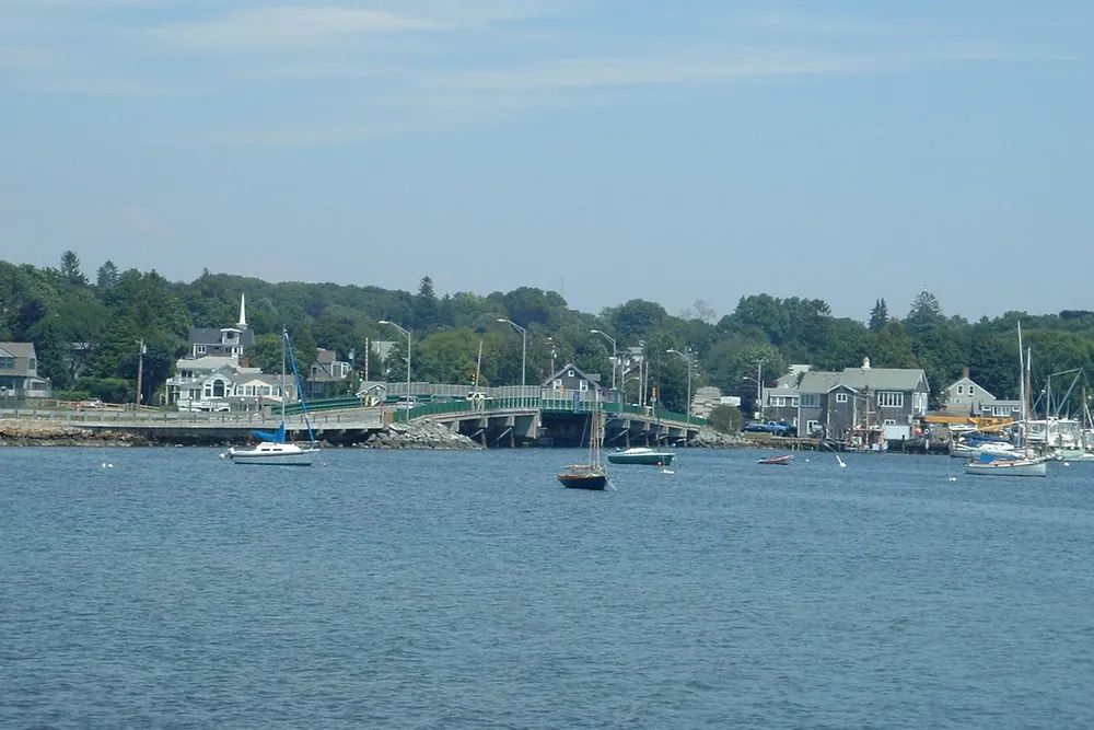 Padanaram harbor in Dartmouth, with the Padanaram Bridge, sailboats and shoreline houses